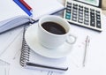 Coffee Cup at Office with Financial Papers,Agenda and Calculator Royalty Free Stock Photo