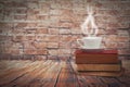 Coffee cup on old book set up on wood table and oldwall Royalty Free Stock Photo