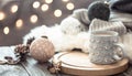 Coffee cup over Christmas lights bokeh in home on wooden table with sweater on a background and decorations. Holiday decoration Royalty Free Stock Photo