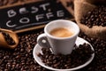 Coffee cup over dark roasted coffee beans Royalty Free Stock Photo