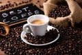 Coffee cup over dark roasted coffee beans Royalty Free Stock Photo