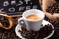 Coffee cup over dark roasted coffee beans Royalty Free Stock Photo