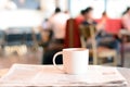 Coffee cup over newspaper on the table in coffee shop Royalty Free Stock Photo