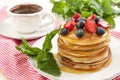 Coffee cup and pancakes with berries