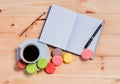 Coffee cup, pen, glasses, opened organizer on wooden background