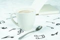 Coffee cup placed on the floor, musical note pattern