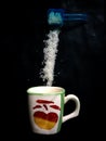 Coffee cup and pouring sugar spoon Royalty Free Stock Photo