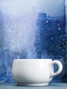 Coffee cup on a rainy day in front of the window Royalty Free Stock Photo