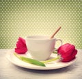 Coffee cup with red tulips Royalty Free Stock Photo