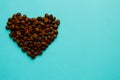 Coffee cup and roasted beans arranged as clock face on blue background, top view. Coffee time symbol. Interesting idea energy and Royalty Free Stock Photo