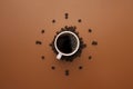 Coffee cup and roasted beans arranged as clock face on brown background. Coffee time concept. Coffee as a symbol of morning energy Royalty Free Stock Photo