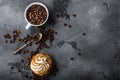 Coffee cup with roasted beans and cup cake on grey textured background, top view with space for text Royalty Free Stock Photo