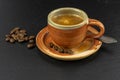 Coffee cup and saucer with coffee beans on a wooden table. Dark background Royalty Free Stock Photo