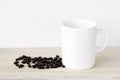 Coffee cup and saucer with coffee beans on wooden table Royalty Free Stock Photo