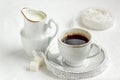 Coffee cup and saucer with milk and sugar on white background Royalty Free Stock Photo