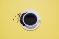 Coffee cup and saucer with spilled coffee beans Royalty Free Stock Photo