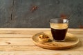Coffee cup and small caramel nut tart on wooden table Royalty Free Stock Photo