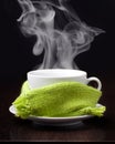 Coffee cup with smoke in green scarf