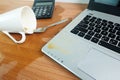 Coffee Cup spill out on Keyboard Laptop computer and smartphone on wooden floor Royalty Free Stock Photo