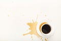 Coffee cup and spilt espresso on white background