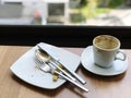 Coffee cup and spoon on wooden table in coffee shop. Royalty Free Stock Photo