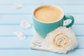 Coffee cup with spring flower and notes good morning on blue rustic background, breakfast Royalty Free Stock Photo