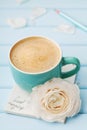 Coffee cup with spring flower and notes good morning on blue rustic background, breakfast Royalty Free Stock Photo