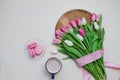 Coffee cup, spring tulip flowers and pink macarons on pastel table top view. Greeting for Womans or Mothers Day Royalty Free Stock Photo