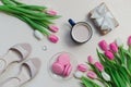 Coffee cup, spring tulip flowers and pink macarons on pastel table top view. Greeting for Womans or Mothers Day Royalty Free Stock Photo