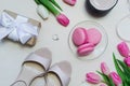 Coffee cup, spring tulip flowers and pink macarons on pastel table top view vertical. Greeting for Womans or Mothers Day Royalty Free Stock Photo