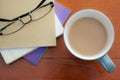 Coffee cup and stack book glasses on red wood table Royalty Free Stock Photo