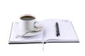 Coffee cup, standing on the daily organizer. Royalty Free Stock Photo