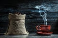 Coffee cup with steam and sack of beans Royalty Free Stock Photo