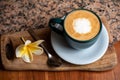 Coffee cup on stone kitchen table. Cappuccino, hot latte or coffee with milk.