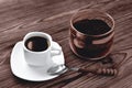 Coffee in a cup on a stone stand ground coffee in a glass jar vintage coffee spoon, wooden natural background, selektive focus