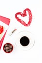 Coffee cup, sweets, lipstick, heart shape and giftbox on white background. Valentine`s Day concept flat lay. Royalty Free Stock Photo