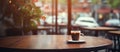 Coffee cup on table in cafe, by window in building with hardwood flooring Royalty Free Stock Photo