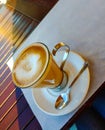 Coffee cup on the table. Close up white coffee cup with a latte art foam. Royalty Free Stock Photo