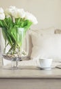 Coffee cup on table with Flowers Blur Sofa Pillows background