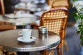 Coffee cup on a table of Parisian outdoor cafe Royalty Free Stock Photo