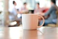 Coffee cup on the table with people in coffee shop as blur background Royalty Free Stock Photo