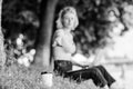 Coffee cup take away close up shot. Coffee cup on green grass woman worker with laptop defocused background. Coffee Royalty Free Stock Photo