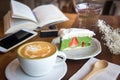 Coffee cup and tasty cake relax time book and mobile phone on ta Royalty Free Stock Photo