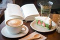 Coffee cup and tasty cake relax time book and mobile phone on ta Royalty Free Stock Photo