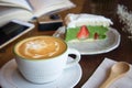 Coffee cup and tasty cake relax time book and mobile phone on ta Royalty Free Stock Photo