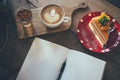 Coffee cup and tasty cake on wood table and Blank paper waiting Royalty Free Stock Photo