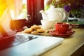 Coffee cup, tea pot ,cookies and laptop Royalty Free Stock Photo