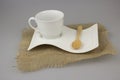Coffee cup with teaspoon on gunny texite. Royalty Free Stock Photo