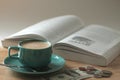 Coffee cup on the teble and book and money