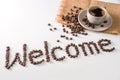 Coffee cup and text made of coffee beans, isolated on white. text the word Welcome made of coffee beans. font Royalty Free Stock Photo
